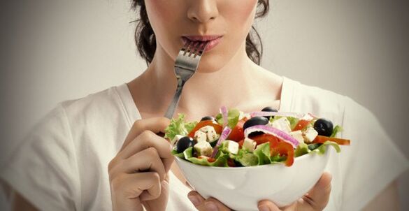 Fată care ține o farfurie de salată